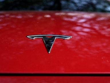 Tesla’s stock slides after profits come up short and EV maker warns of slowing growth in 2024