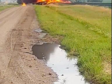 Fiery railcars with hazardous material mostly contained after derailment in North Dakota